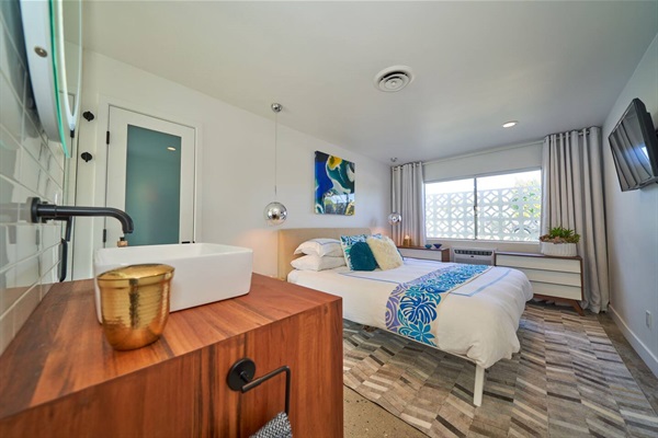 Guest suite with walnut vanity, vessel basin and breeze-block window